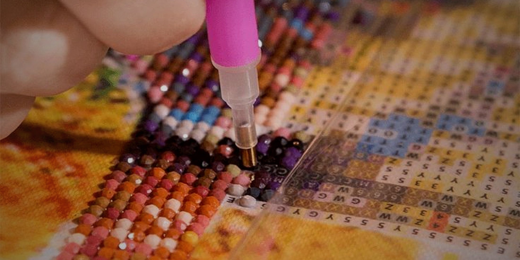 A Veloura artist placing gems on an original diamond painting design